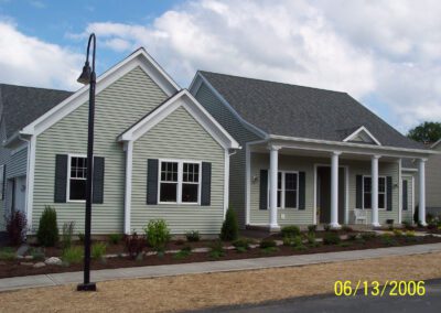 New suburban single-story homes with front porches and a lamppost.